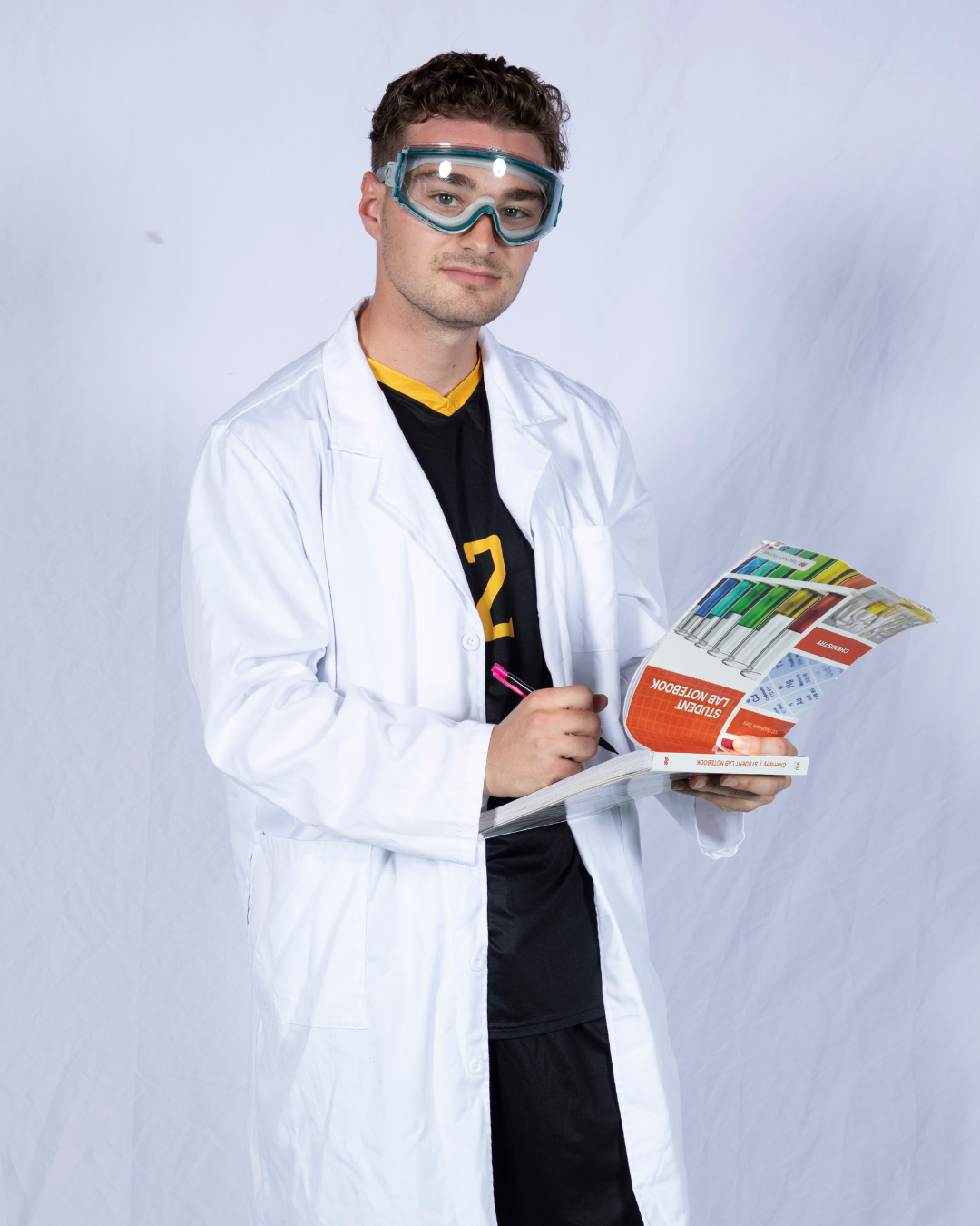 Vinny D’Onofrio writing in a chemistry lab notebook.