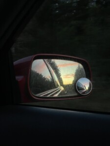 looking in a car rearview mirror
