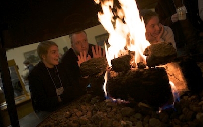 Students sitting by fireplace