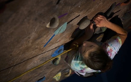 Student climbing rock