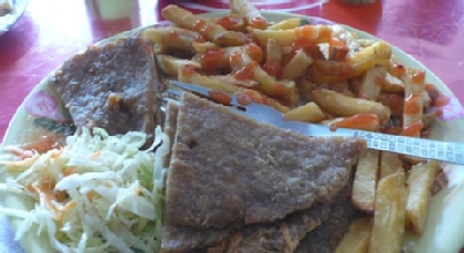 Plate of food including french fries and coleslaw