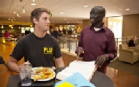 Nick Miller ’10, anthropology major, and David Akuien ’10 talk during lunch. The two became friends while working together in Conferences and Events for the past three years.