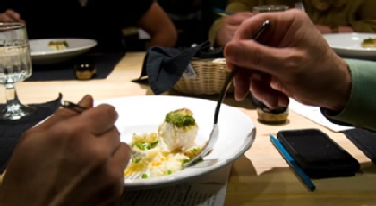 Two people eating from a plate