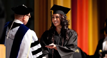Student receiving diploma from President Anderson