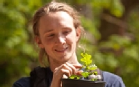 Reed Ojala-Barbour holds one of the Garry oak saplings that will one day take root on the PLU campus.