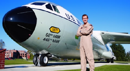 Ed Hrivnak '96 standing next to a jet