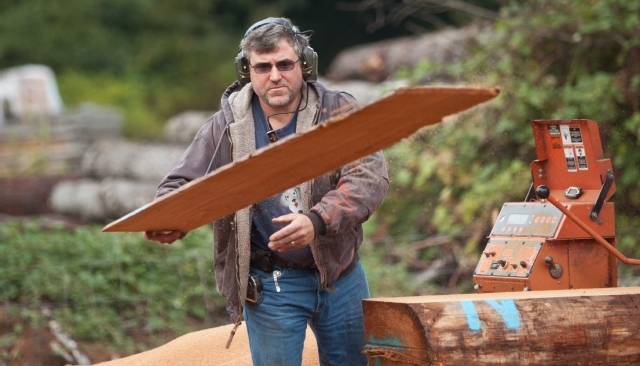 Chris Fry works logs at his lumber mill in Spanaway.