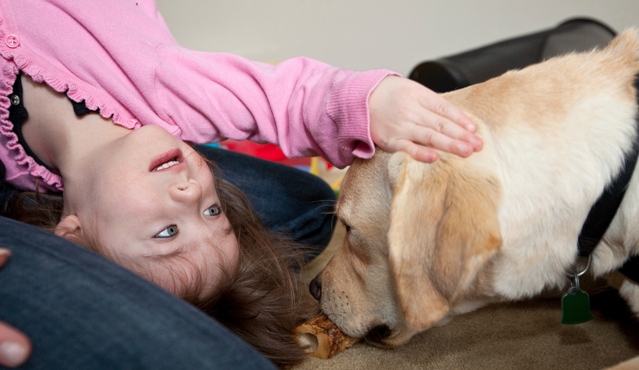 Isabel Moore plays with her new therapy dog Luka. 