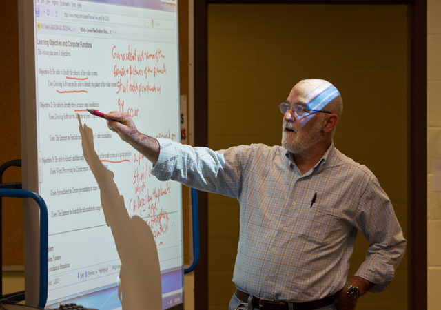 PLU Professor Lenny Reisberg uses a smart board during instruction for a course he teaches. (Photo by John Froschauer)