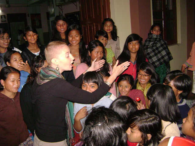Karissa Bryant ’03 with school girls at Sacred Heart Boarding School in Shillong, India. Here Bryant is asking the girls who live at the school what they wanted to be when they grew up.