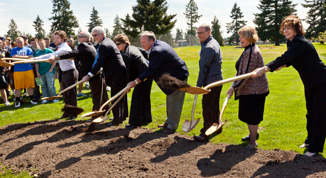 From the right, Kim Wilson '76, Sheri Tonn, Tom Absher, Brad Cheney, Laurie Turner, Bruce Bjerke, Frank Hewins '86, and Thomas Suek '12, shovel dirt. (Photo by John Froschauer)