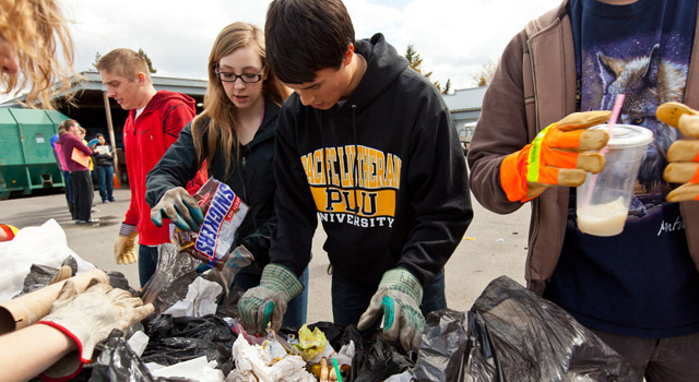 PLU students sort through garbage and learn how much of what is thrown away can be recycled. (Photos by John Froschauer)