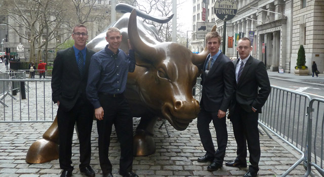 Mary Lund Davis Student Investment Club board members Cameron Lamarche ’12, Kirk Swanson ’12, Phillip Magnussen ’13 and Arne-Morten Willumsen ’13 pose in front of the Wall Street Bull in New York City during the G.A.M.E. Conference.