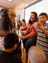 Dixie Pyle '10 holds on to a Styrofoam track as students drop a marble from the top and see if it can make the loop.