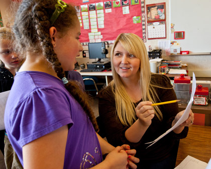 Sophia Stover ’08 reviews a student’s work at James Sales Elementary.