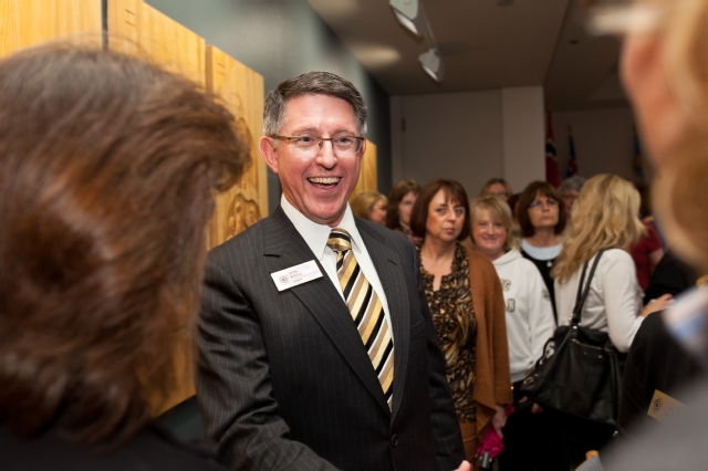 President Thomas Krise is greeted by well wishers at an informal reception in the Scandinavian Center to mark his first day on the job. (Photo by John Froschauer)