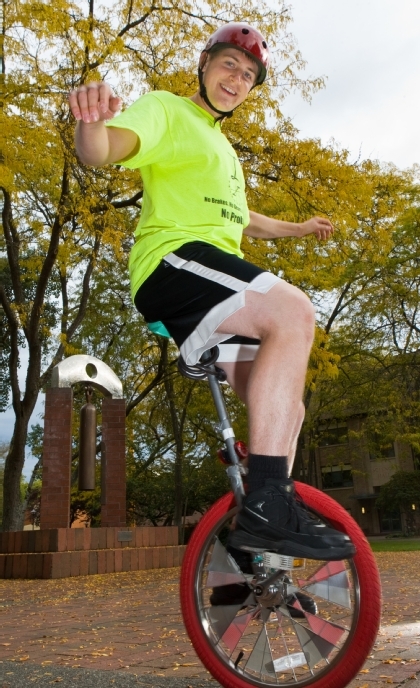Bendzak clowning around on a unicycle before graduating from PLU in 2010. (Photo by Jordan Hartman)