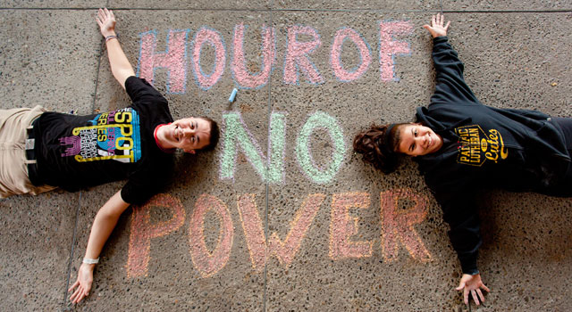 Doug Smith ’15 and Aiko Nakagawa ’15 after chalking advertising for “unPLUg” a sustainability and low power use push at PLU. (Photo by John Froschauer)