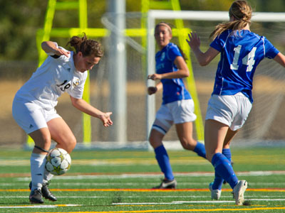 Erica Boyle intercepts a pass during the first match played at PLU’s new soccer complex. Photo by John Froschauer.