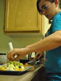 Dell’Osa adds some sliced grape tomatoes to her salad.