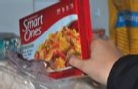 person holding smart ones frozen dinner