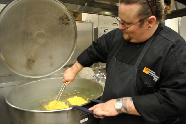 PLU cook Chuck Blessum boils noodles for dinner in the University Commons.