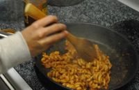 Jared Kavanaugh ’13 heats up leftover pasta on the stove.