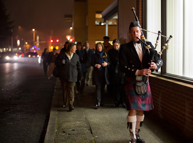 Sam Horn ’15, leads a traditional march for a Robbie Burns themed night at the Garfield Book Company. (Photo by John Froschauer)