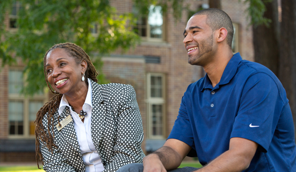 Melannie Denise Cunningham ’12 and Victor Bull ’10 hang out near Red Square on the PLU campus.