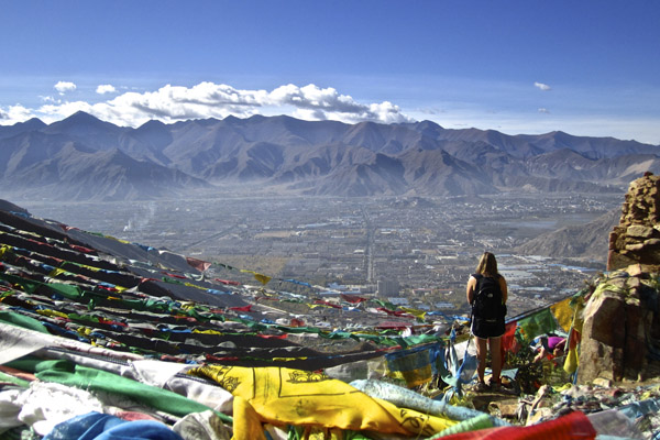 Tibet 2012, student standing on a hill of tied flags, submitted by Evan Koepfler