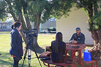 Two students interviewing a citizen on the importance of water and perils facing our world’s most important natural resource