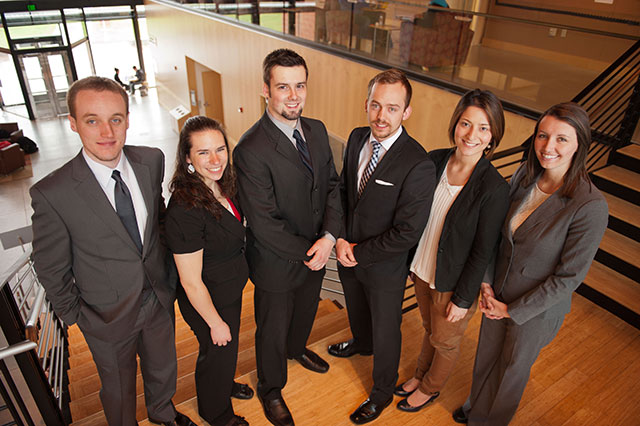 Zach Grah ’13, left, and his fellow students ran a simulated company for 20 consecutive quarters, culminating in a competition against 29 other universities in Long Beach, Calif. (Photo by John Strutzenberg)