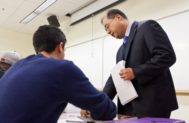 Assistant Professor Brian Maeng works with a student in class. Maeng teaches Operations Management and Management Information Systems at Pacific Lutheran University. (Photo by John Froschauer)