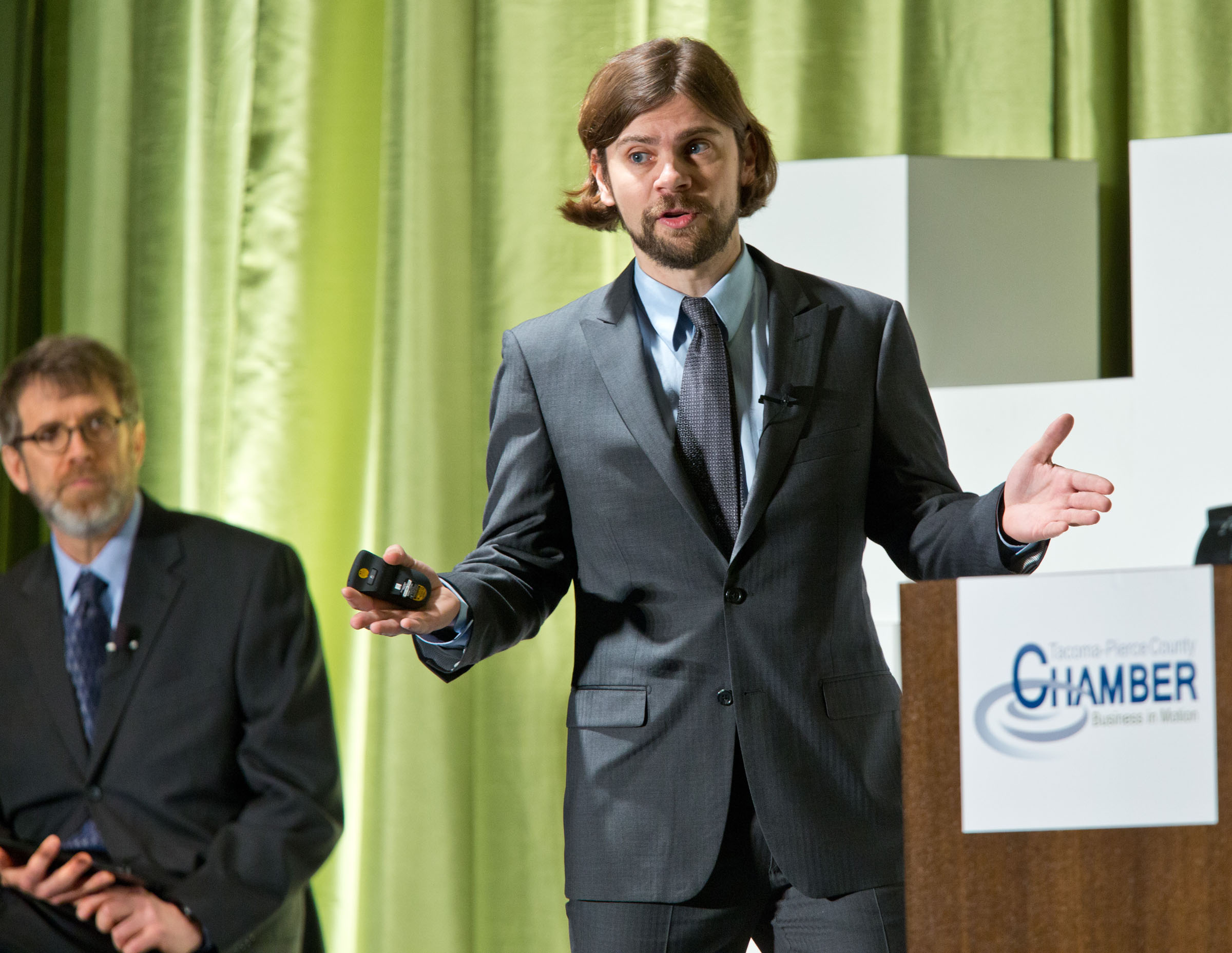 PLU Economics Professor Dr. Martin Wurm addresses the Pierce County Economic Index forum on Jan. 9, 2014, as fellow Professor Neal Johnson looks on.