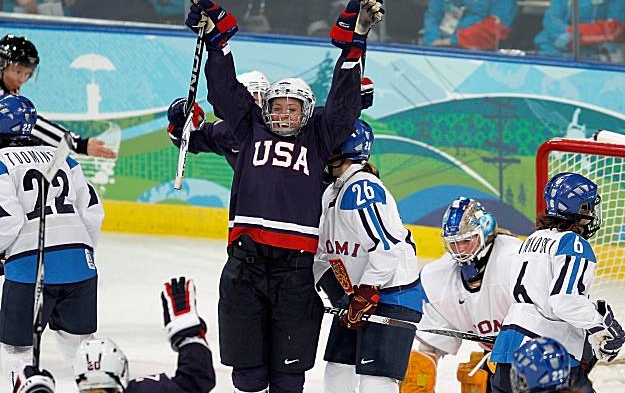 USA woman hockey player jumps for joy as she makes a goal