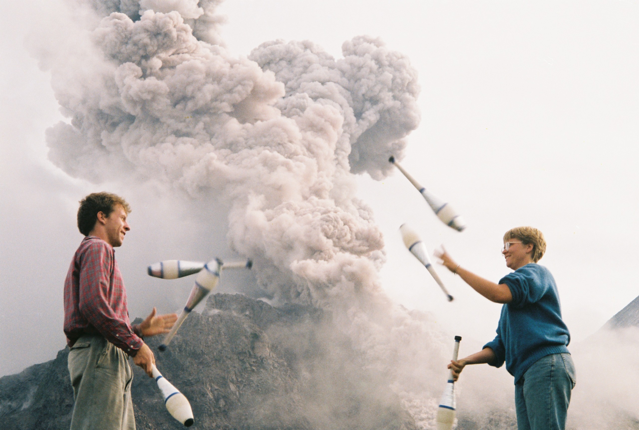 Curt Malloy, left, and Barbara Naess juggle in the shadows of a volcano in Volcán Santiaguito, Guatemala. (Photo: Bill Latham)