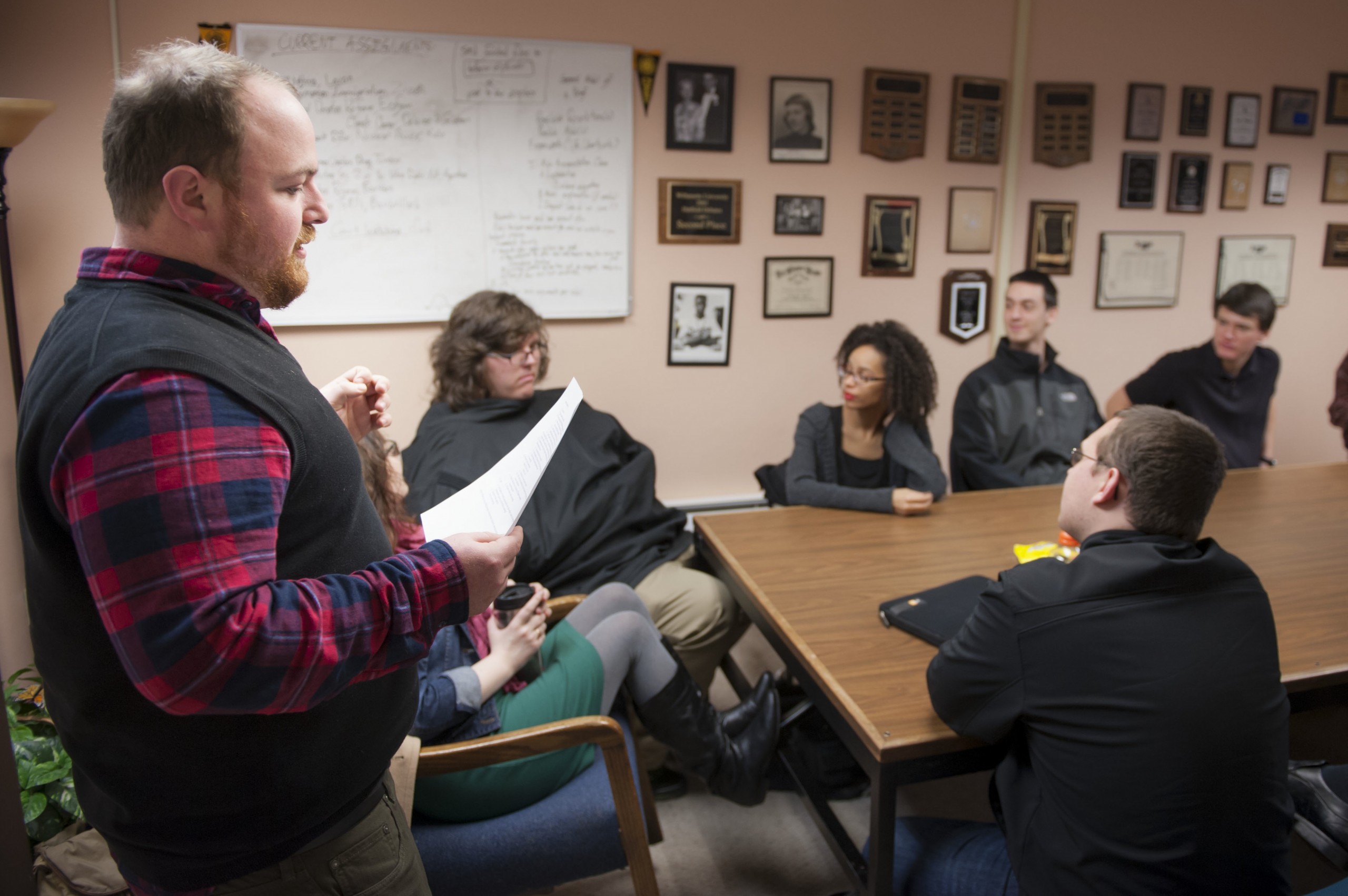 PLU Director of Forensics Justin Eckstein, left, who was honored at the national competition, addresses the Speech and Debate team in February. (Photo: John Struzenberg ’15)