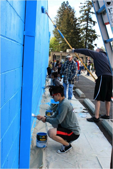 PLU students prepare the Parkland Post Office wall for a community mural. (Photo: Parkland Community Mural Project)