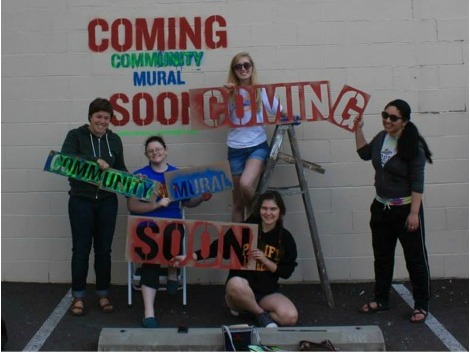 PLU students prepare the Parkland Post Office wall for a community mural. (Photo: Parkland Community Mural Project)