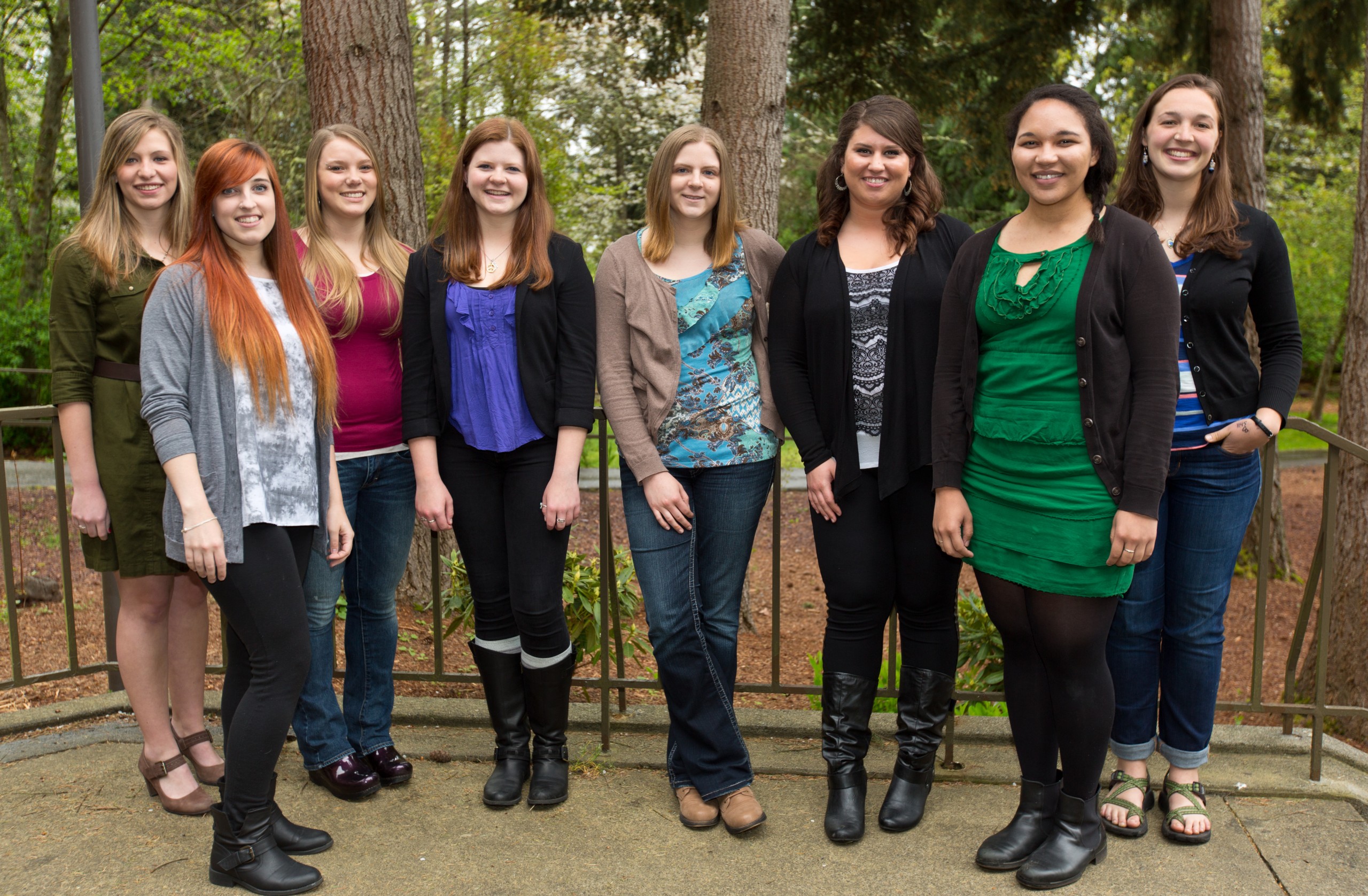 Communication Professor Amanda Feller’s peace-building cohort, all graduating in 2014, comes together at PLU. From left: Caitlin Zimmerman, Lauren Corboy, Sydney Barry, Kendall Daugherty, Rachel Samardich, Rachel Espasandin, Jessica Sandler and Anna McCracken. (Photo: John Froschauer/PLU)