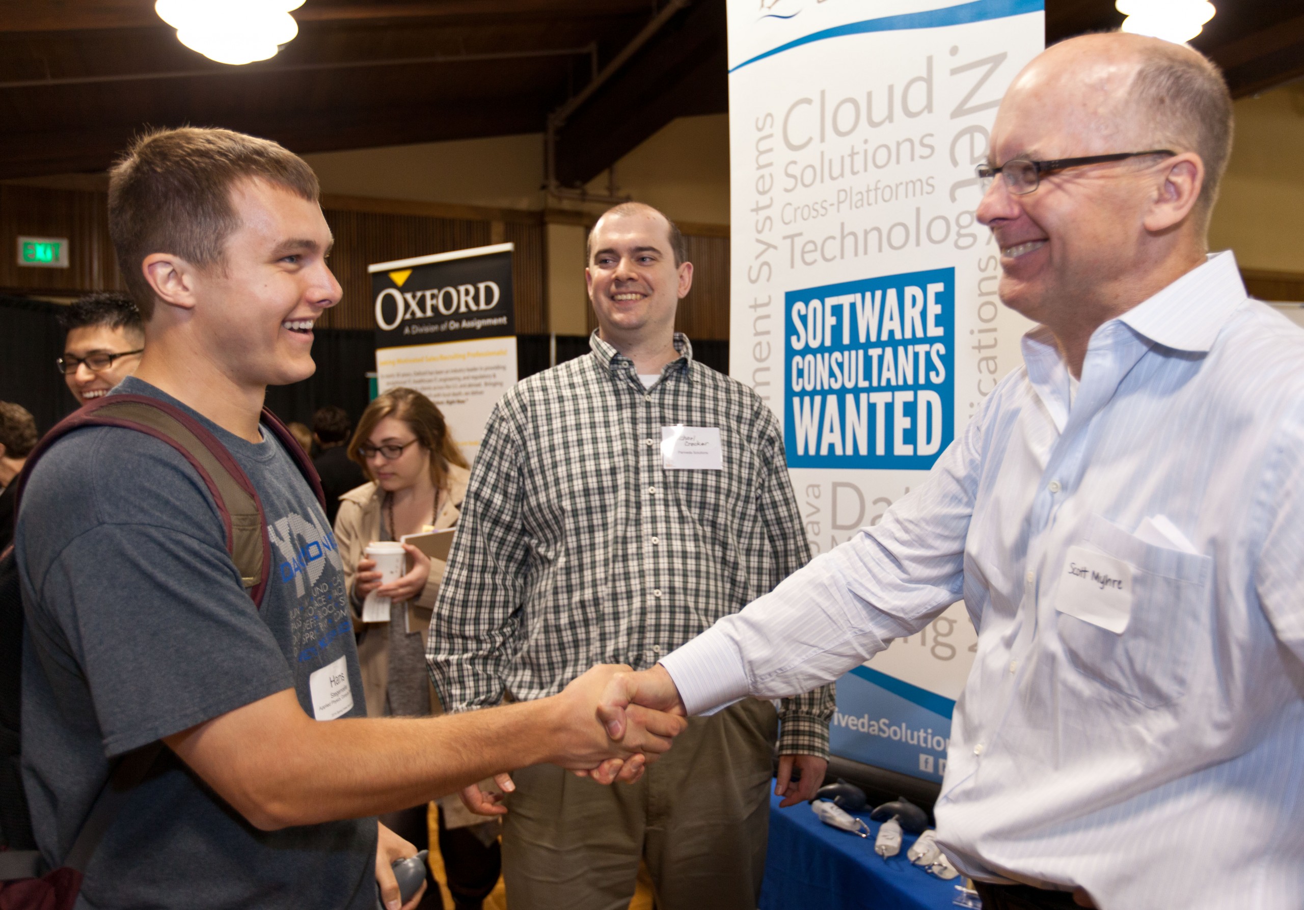 Hans Stegemoeller ’14 shakes hands with Scott Myhre of Pariveda Solutions at the 2014 Career Expo at PLU. (Photo: John Froschauer/PLU)