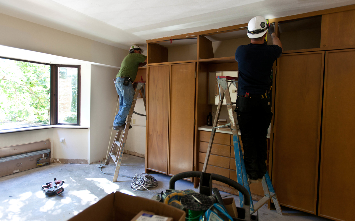 Workers install new furnishings in a Stuen Hall room on July 8. The renovated residence hall will be ready for residents in Fall 2014. (Photo: John Froschauer/PLU)