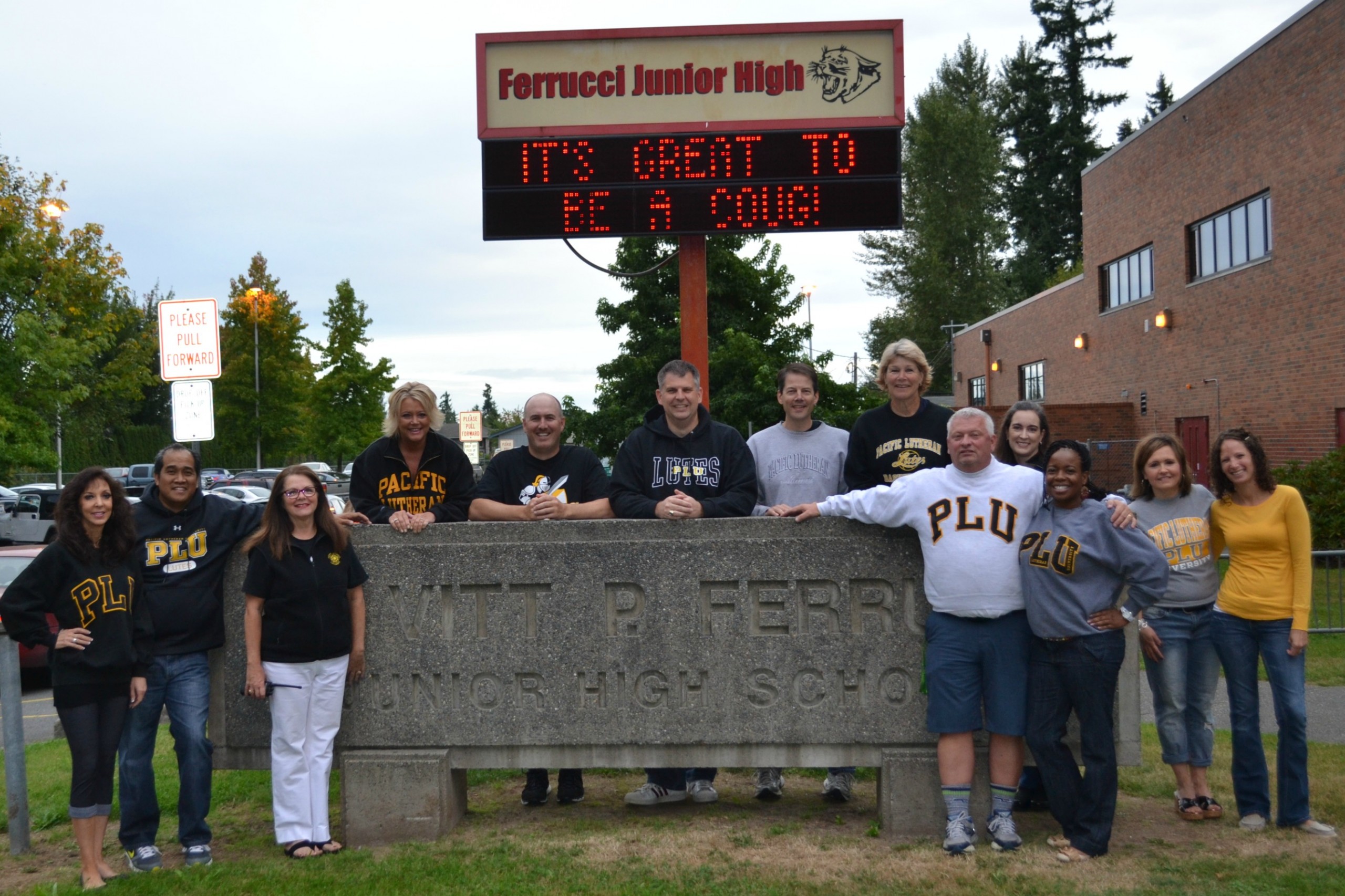 A quorum of the 15 Lutes on staff at Ferrucci Junior High pose for a group photo outside the Puyallup school. From left: Jeanine Wernofsky ’82, Ron Baltazar ’00, Joan Forseth ’91, Kim Lawson ’82, Brent Anderson ’97, Steve Leifsen ’96, Bob Rink ’92, Cindy VanHulle ’76, Baron Coleman ’02, Erica Lightbody ’95, Tawana Bens ’05, Krista McBride ’90 and Deirdre Davis ’05. Two more Lutes are not pictured: Dan Floyd ’92 and Brooke Gustafson ’05. (Photo courtesy of Ferrucci Junior High)