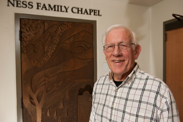 The Rev. Richard Tietjen stands in front of a piece of artwork by former PLU Professor Ernst Schwidder. Schwidder's art is found all across the country, including in PLU's Karen Hille Phillips Center for the Performing Arts. (Photo: John Struzenberg '16)