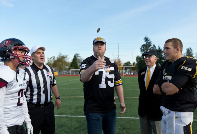 Steve Shumaker, a Political Science major at PLU who served in the U.S. Army for 12 years, tosses the coin at the Nov. 8 Military Football Game at Sparks Stadium in Puyallup. (Photo: John Froschauer/PLU)