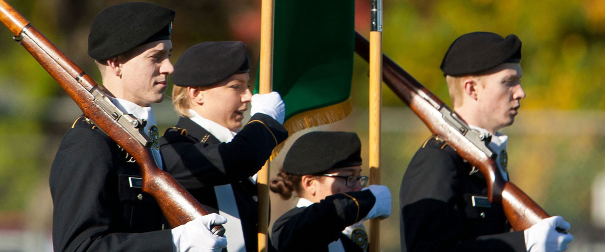 ROTC students presenting the U.S. Flag in a football game