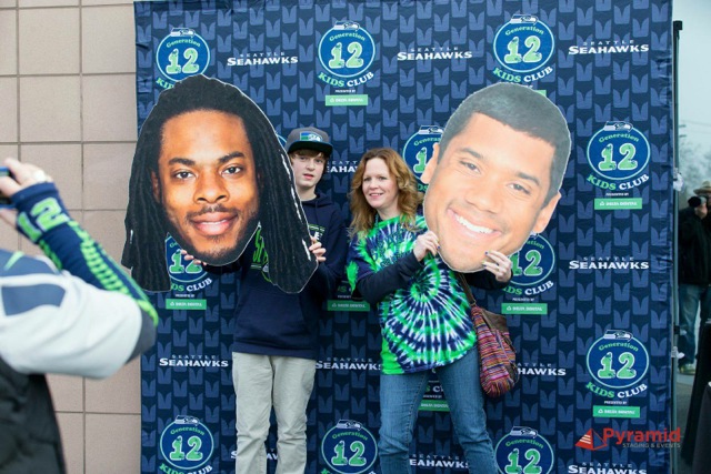 Seattle Seahawks events set up and staged by 2014 MBA graduate Stephen Dilts’ company, Pyramid Staging & Events, LLC. (Photos courtesy John Patzer Photography.) Mom and son peaking from behind Russell Wilson and Richard Sherman cutouts.