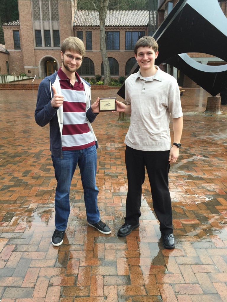 Debate duo Max Bartholomew and Sam Altenberger pose with their semi-finalist plaque. (Photo: Tori Vigil, PLU)