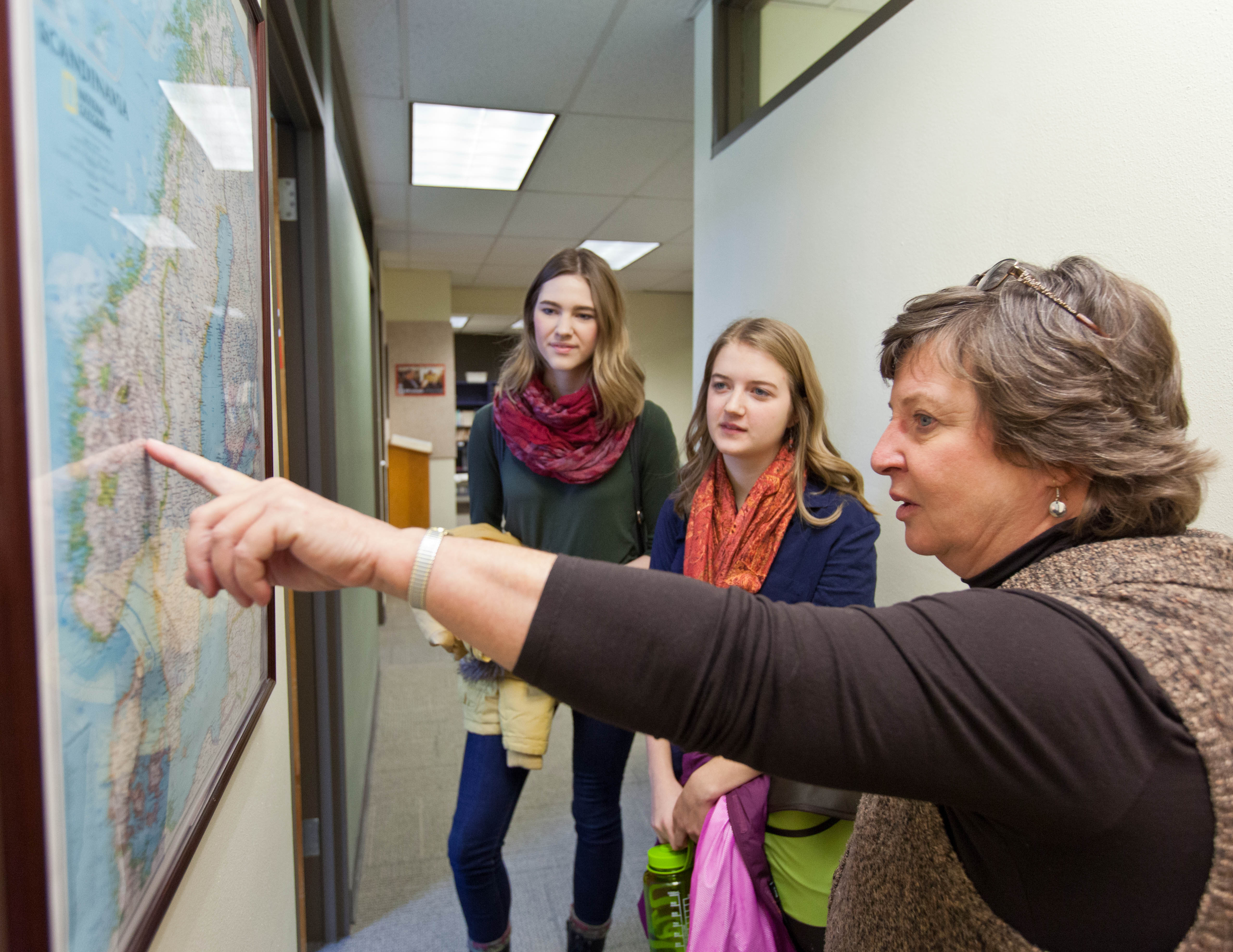 Claudia Berguson, Peace Scholar coordinator and associate professor of Norwegian and Scandinavian Area Studies, shows Peace ScholarsTaylor Bozich, left, and Ellie Lapp where they'll be studying in Norway. (Photo: John Froschauer/PLU)