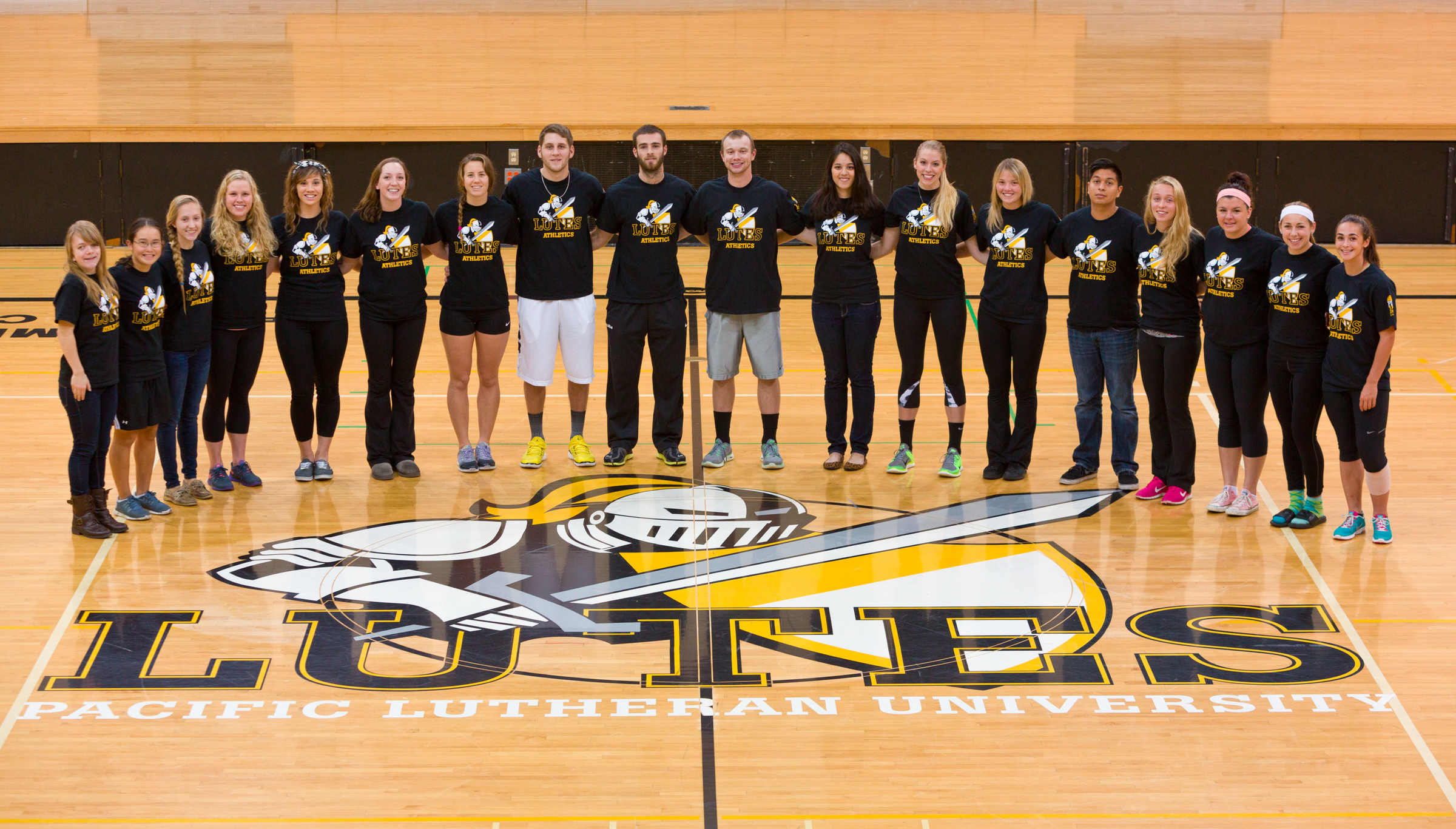 Student-athletes teamed in Olson Auditorium to show support for the Drive to 125From left: Jessica Hunter ’16, rowing; Kailyn Osaki ’17, softball; Madison Silva ’15, cross country; Sarah Ameny ’17, swimming; Toni Castillo ‘15, swimming; Melissa Dean ’16, swimming; Reese Ackman ’17, swimming; Kyle Sawtell ’17, basketball; Erik Swartout ’17, basketball; Cory Nelson ’16, baseball; Allison McClure ’15, tennis; Amy Wooten ’15, volleyball; Nicoya Benham-Marin ’16, soccer; Rigoberto Loreto ’17, soccer; Kelly White ’17, soccer; Bryce Kennedy ’16, soccer; Hannah Walton ’16, track and field; Machaela Graddy ’18, soccer. (Photo by John Froschauer/PLU)